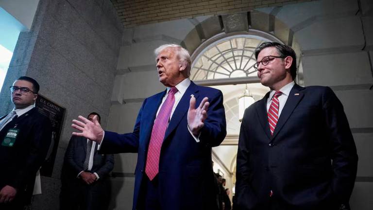 U.S. President Donald Trump gestures next to U.S. House Speaker Mike Johnson (R-LA), on the day of a closed House Republican Conference meeting on Capitol Hill in Washington, D.C., U.S., May 20, 2025. REUTERS/Ken Cedeno