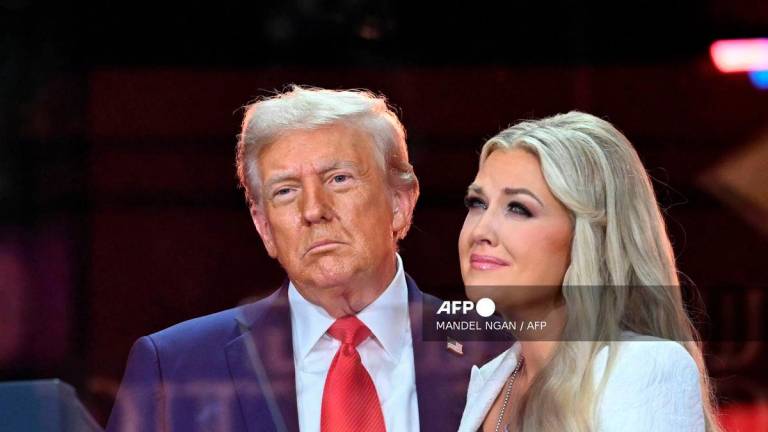 US President Donald Trump greets Erika Kirk, Charlie Kirk's widow during the public memorial service for right-wing activist Charlie Kirk at State Farm Stadium in Glendale, Arizona, on September 21, 2025. - AFP