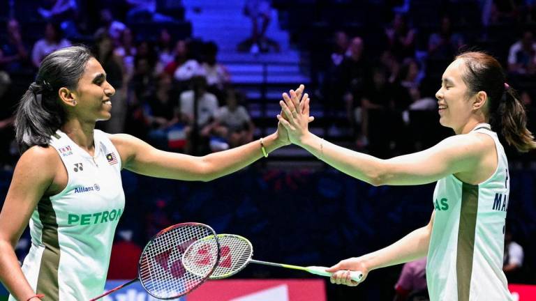 Malaysia's Pearly Tan and Malaysia's M. Thinaah react during during the women's round of 32 doubles match against Hong Kong's Lui Lok Lok and Hong Kong's Tsang Hiu Yan at the Badminton BWF World Championships at the Adidas Arena in Paris, on August 27, 2025. - AFPPIX