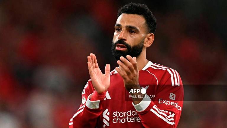 Liverpool's Egyptian striker #11 Mohamed Salah applauds fans after the English Premier League football match between Liverpool and Bournemouth at Anfield in Liverpool, north west England on August 15, 2025. Liverpool won the game 4-2. - AFP