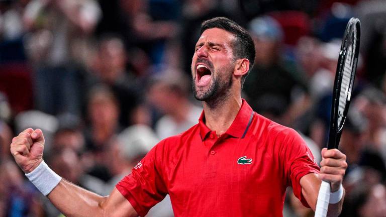 Serbia’s Novak Djokovic celebrates after winning against Germany’s Yannick Hanfmann during their men’s singles match at the Shanghai Masters tennis tournament. - Hector RETAMAL / AFP