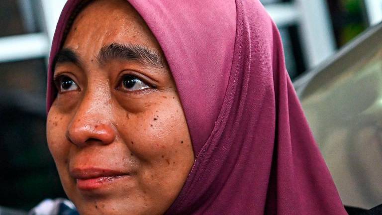 Norfazila Md Lajin, the mother of student Abdul Fatah Khairol Rizal, appeared emotional when met by reporters at her home in Kampung Masjid yesterday. – BERNAMA