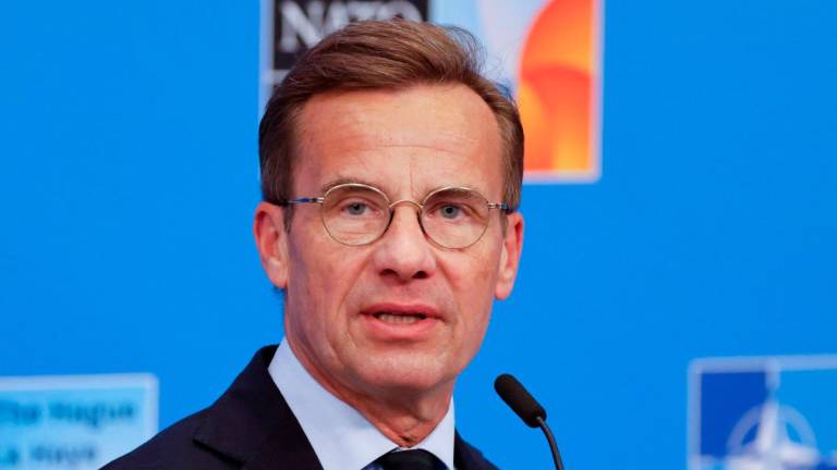 Sweden’s Prime Minister Ulf Kristersson speaks to the media upon arriving to attend the North Atlantic Treaty Organization (NATO) Heads of State and Government summit in The Hague, on June 25, 2025. (Photo by Ludovic MARIN / POOL / AFP)