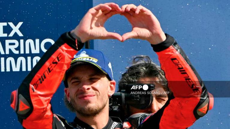 Aprilia Racing team's Italian MotoGP rider Marco Bezzecchi celebrates his second place at the end of the San Marino Moto GP Grand Prix at the Misano World Circuit Marco Simoncelli, in Misano Adriatico, northern Italy, on September 14, 2025. - AFP