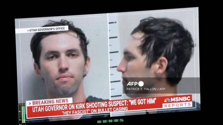 A TV monitor displays a picture of Tyler Robinson, the suspected of killing Charlie Kirk on September 11, in Orem, Utah, on September 12, 2025. (Photo by Patrick T. Fallon / AFP)