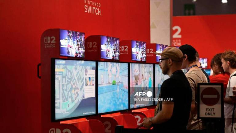 Gamers play the Pokemon-Legends: Z-A video game at the Ninentdo booth during the Gamescom video games trade fair at the Trade Fair Center in Cologne, western Germany, on the first day of the fair on August 20, 2025. - AFP