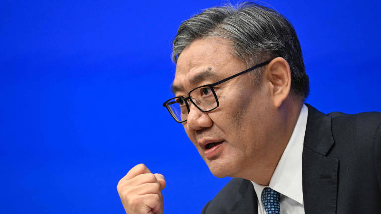 Wang Wentao, China’s Minister of Commerce, speaks during a press conference in Beijing on July 18, 2025. China's economy is still facing a very severe and complex situation, its minister of commerce said on July 18, suggesting the government would take action to counter challenges ahead. - AFP