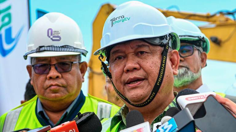 Works Minister Datuk Seri Alexander Nanta Linggi (centre) answers questions from reporters during a press conference at the Groundbreaking Ceremony for Malaysia’s First Integrated EV Charging Hub at the Seremban R&amp;R (Southbound), today. – BERNAMA