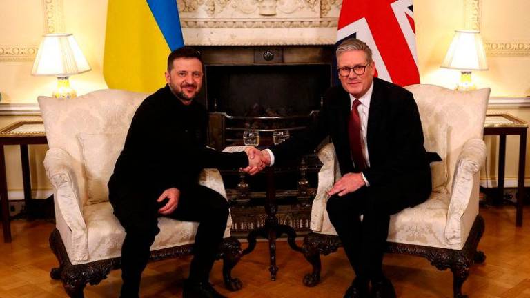 British Prime Minister Keir Starmer and Ukrainian President Volodymyr Zelenskiy shake hands during a bilateral meeting - REUTERSpix