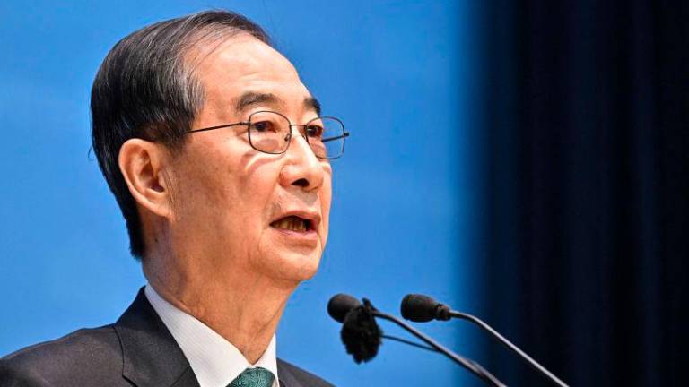 Former acting president Han Duck-soo speaks to formally announce his candidacy in next month’s presidential election at the National Assembly in Seoul on May 2, 2025 AFPpix