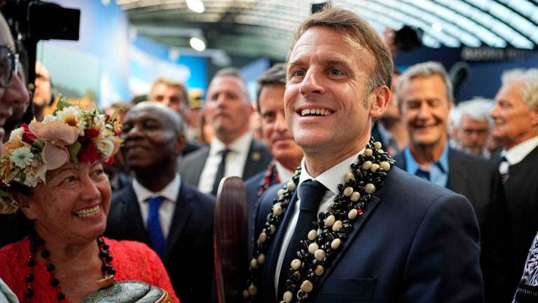 France’s President Emmanuel Macron (R) visits the French Polynesia stand at “La Baleine” (The Whale) exhibition centre one day ahead of the opening of the third UN Ocean Conference (UNOC) a high-level summit on ocean conservation, as nations face pressure to adopt tougher stances on overfishing, pollution and marine protection, in the French Riviera city of Nice on June 8, 2025.