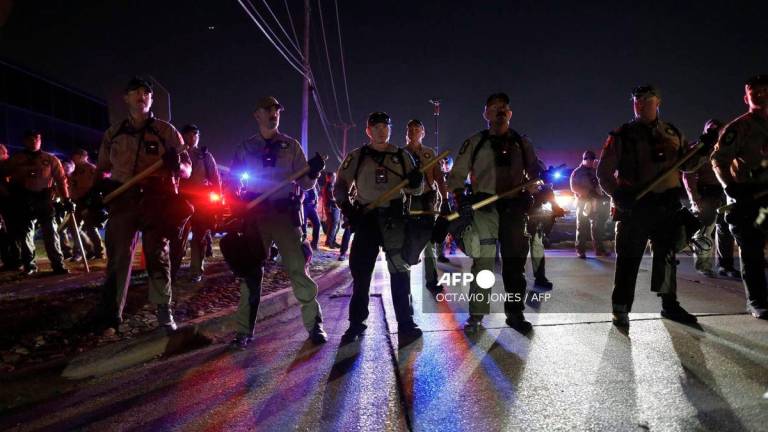 Illinois State Police stand guard while monitoring protesters gathering near an Immigration and Customs Enforcement (ICE) facility in Broadview, Illinois, on October 4, 2025. - AFP