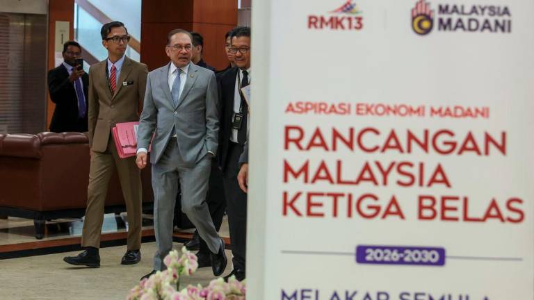 Prime Minister Datuk Seri Anwar Ibrahim arriving at the Dewan Negara to present the 13th Malaysia Plan (RMK13) on August 25, 2025. - BERNAMA