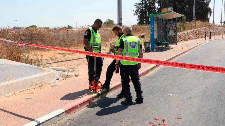 Israeli police conduct a search at the site of a reported ramming attack in the central Israeli city of Kfar Yona on July 24, 2025. (Photo by Jack GUEZ / AFP)