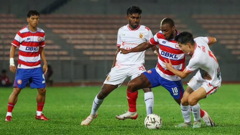 Kuala Lumpur City FC player Kpah Sherman (second from right) is challenged by two players from Kelantan The Real Warriors FC during the 2025/2026 FA Cup match at the Kuala Lumpur Football Stadium last night. - BERNAMA