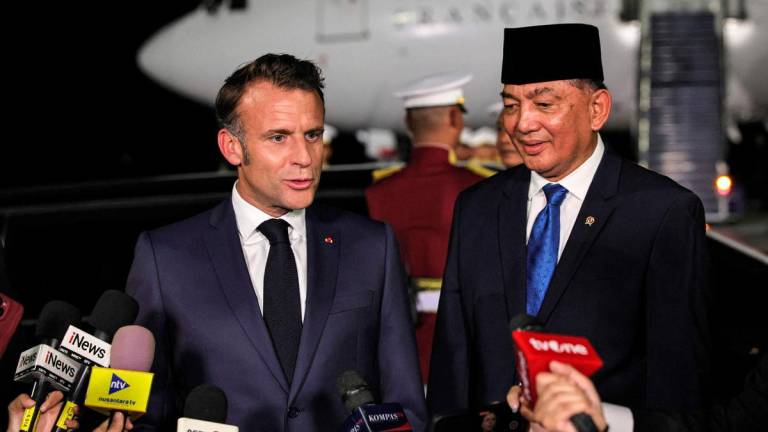 France’s President Emmanuel Macron (L) and Indonesia’s Defence Minister Sjafrie Sjamsoeddin (R) speak to the press upon arrival at Halim Perdanakusuma International Airport in Jakarta on May 27, 2025. AFPpix
