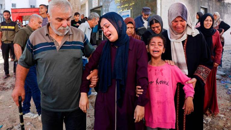 Mourners cry during a funeral service of a person killed a day earlier while attempting to get aid at a distribution point near the Israeli-controlled Zikim border crossing, at Al-Shifa hospital in Gaza City, on June 24, 2025. The Ramallah-based Palestinian Authority demanded on June 24 that a ceasefire deal announced in the Iran-Israel war be widened to include the ongoing conflict in Gaza. - Omar AL-QATTAA / AFP