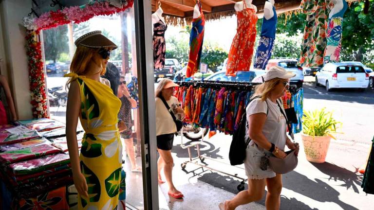 A photo taken on June 11, 2025 shows tourists shopping on the main island of Rarotonga. AFPPIX