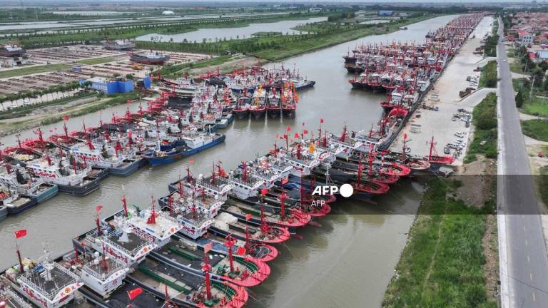 Fishing boats shelter at a fishing port ahead of the arrival of Typhoon Co-May in Lianyungang, in China’s eastern Jiangsu province on July 30, 2025. - AFP / China OUT