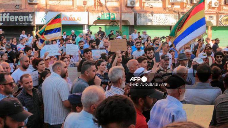 Syrians gather to protest the humanitarian situation in the predominantly Druze city of Sweida on July 28, 2025. - Shadi AL-DUBAISI / AFP