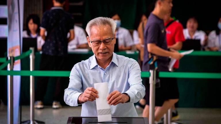 Macau’s Chief Executive Sam Hou-fai casts his vote at the Salesian Institute of the Immaculate Conception polling station during the Legislative Assembly election in Macau on September 14, 2025. (Photo by Eduardo Leal / AFP)