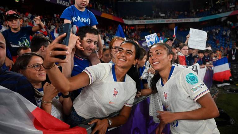France’s defender #13 Selma Bacha (R) poses for a selfie as she celebrates her team’s victory with fans at the end of the UEFA Women’s Euro 2025 Group D football match between The Netherlands and France at the St. Jakob-Park Stadium in Basel, on July 13, 2025. Photo by Miguel MEDINA / AFP