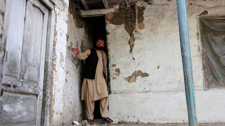 Jabar Khan, 43, looks at damage at the house of his neighbour, following a deadly earthquake in Bambakot village in Dera Noor district in Nangarhar province, Afghanistan September 6, 2025. REUTERS/Sayed Hassib