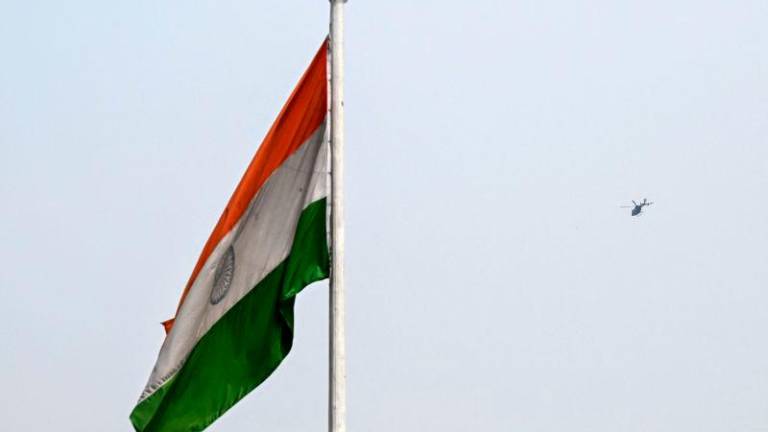 The Indian national flag flutters as a military helicopter flies over the skies of Srinagar on May 2, 2025. AFPpix