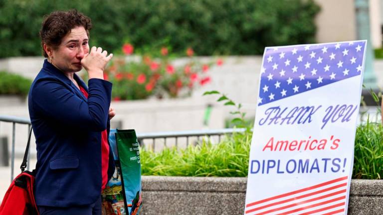 A woman cries during a sendoff event for State Department workers in Washington, D.C., U.S., July 11, 2025. REUTERS