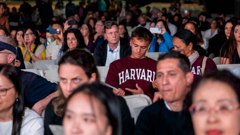 People watch as the Harvard Glee Club and Harvard University Band perform during a concert at Harvard Yard on May 27, 2025 in Cambridge, Massachusetts. AFPpix