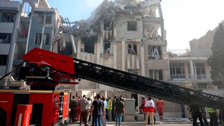 Rescue teams work outside a heavily damaged building, targeted by an Israeli strike in the Iranian capital Tehran. AFPPIX