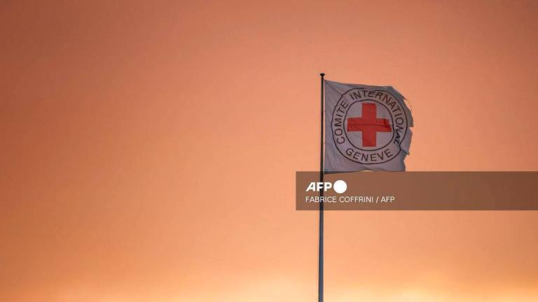 A flag of the Comite International Geneve (International Committee of the Red Cross ICRC) is seen fluttering in the wind on the top of the humanitarian organization's headquarters in Geneva, on August 14, 2025. - AFP