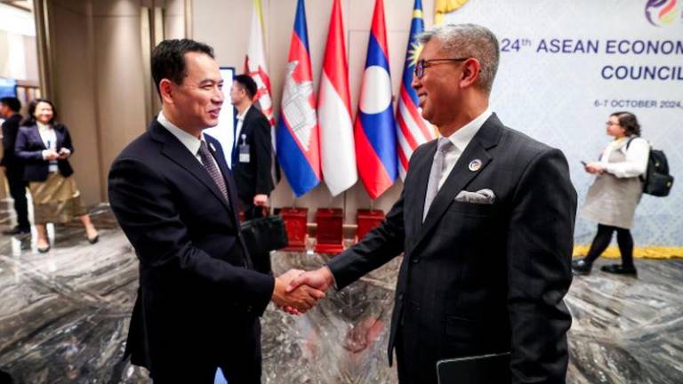 Investment, Trade, and Industry Minister Tengku Datuk Seri Zafrul Abdul Aziz (right) with the Lao Minister of Industry and Commerce Malaythong Kommasith, while attending 24th ASEAN Economic Community (AEC) Council Meeting during the 44th and 45th ASEAN Summits and Related Summits at a hotel today. - BERNAMAPIX