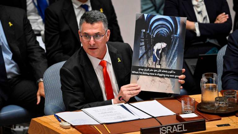 Israel’s Foreign Minister Gideon Sa’ar holds up an image of hostage Evyatar David during a United Nations Security Council meeting on the conflict in the Middle East, including the Palestinian question, at United Nations headquarters. AFPPix