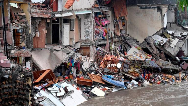 Damaged and collapsed houses due to flooding are seen following heavy rain in Denpasar, Indonesia’s Bali island, on September 10, 2025. - SONNY TUMBELAKA / AFP