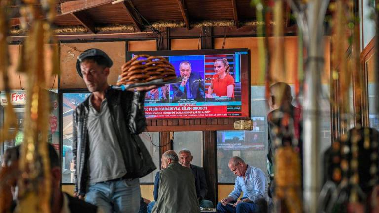 This photograph shows a screen announcing of PKK's (Kurdish Workers Party) dissolution on the News on a television screen inside a traditional Turkish tea house, in Diyarbakir, on May 12, 2025. - AFPPIX