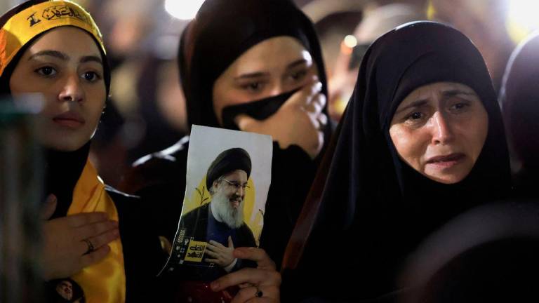 Hezbollah supporters react as they gather at the site where the group's late leader Hassan Nasrallah was killed, before the first anniversary of his assassination in an airstrike, in Beirut's southern suburbs, Lebanon, September 26, 2025. - REUTERSPIX