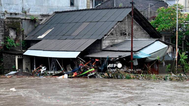 A house is inundated by floodwaters following heavy rain in Denpasar, Indonesia’s Bali island, on September 10, 2025. (Photo by SONNY TUMBELAKA / AFP)