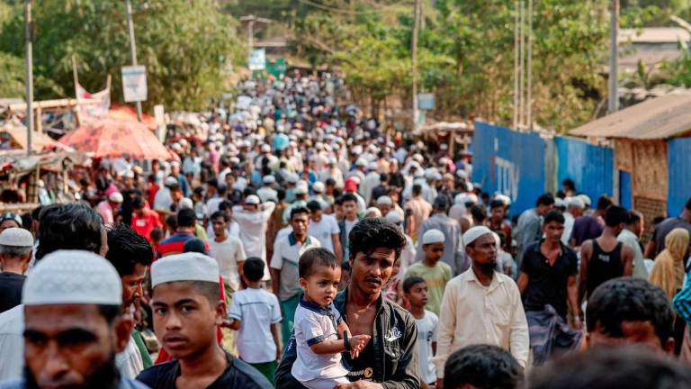 Rohingya refugees gather at roadside kitchen market, at the refugee camp in Cox's Bazar, Bangladesh, March 15, 2025. - REUTERSPIX