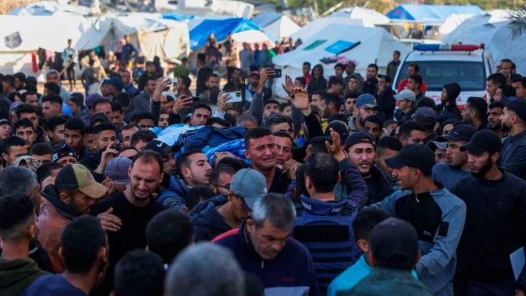 Relatives and colleagues carry the body of Palestinian journalist Hussam Shabat, who collaborated with Al Jazeera Mubasher, during his funeral in Beit Lahia, in the northern Gaza Strip, on March 24, 2025. AFPpix