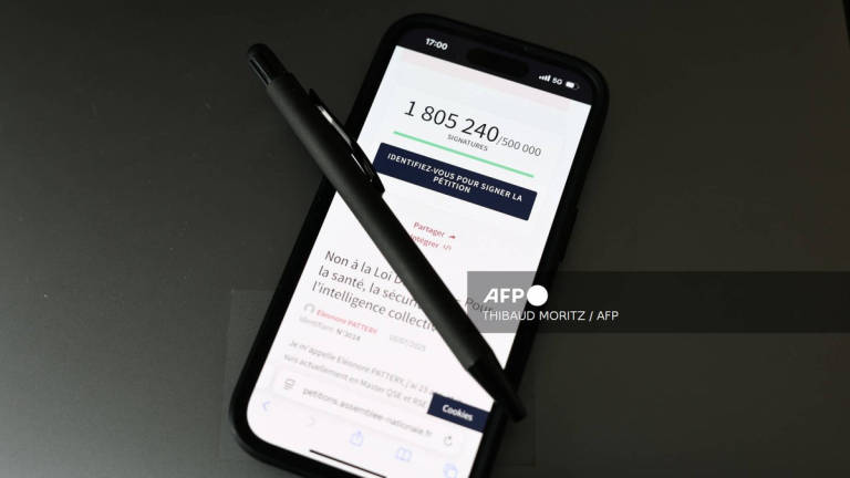 This photograph, taken on July 23, 2025 in Paris, shows a pen and a smart-phone screen displaying the French National Assembly website showing the number of citizens who had signed the petition against the Duplomb law “Non à la loi Duplomb - pour la santé, la sécurité, l'intelligence collective” (No to the Duplomb law - for health, safety and collective intelligence). - AFP