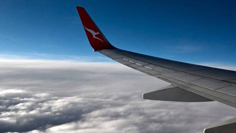 This picture taken on June 29, 2025 shows a Qantas plane flying over Perth. Australian airline Qantas said on July 2, 2025 it was investigating a significant cyberattack, after hackers infiltrated a system containing sensitive data on six million customers. - AFPPIX