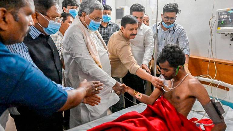 Chief Minister of Karnataka Siddaramaiah (Centre L) visits a victim of the stampede that occured during the RCB cricket victory celebrations, at a hospital in Bengaluru on June 4, 2025. - AFPpix