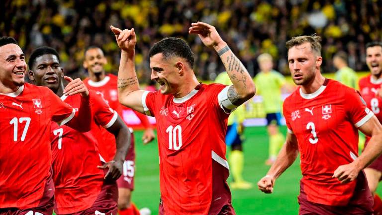 Switzerland’s Granit Xhaka celebrates scoring their first goal with teammates Jonas Ekstromer/TT News Agency via REUTERS