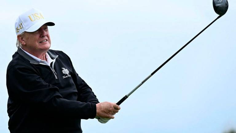 US President Donald Trump watches his drive after playing from the first tee to officially open the Trump International Golf Links course in Balmedie, Aberdeenshire, north east Scotland on July 29, 2025. - SMIALOWSKI / AFP