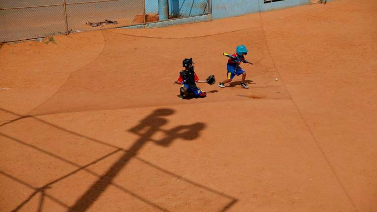 FILE PHOTO: Players from Cacique Mara Little League baseball team, practice during training at Cacique Mara stadium in Maracaibo, Venezuela, August 30, 2019- REUTERS