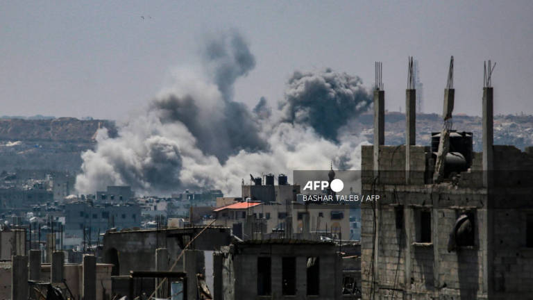 This picture taken from western Jabalia in the central Gaza Strip shows smoke billowing east of Gaza City, in the central Gaza Strip following Israeli strikes on July 13, 2025. - AFP