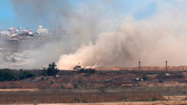 A picture taken from a position at the Israeli border with the Gaza Strip, shows an Israeli Tank moving in the besieged Palestinian territory on August 1, 2025. - Jack GUEZ / AFP