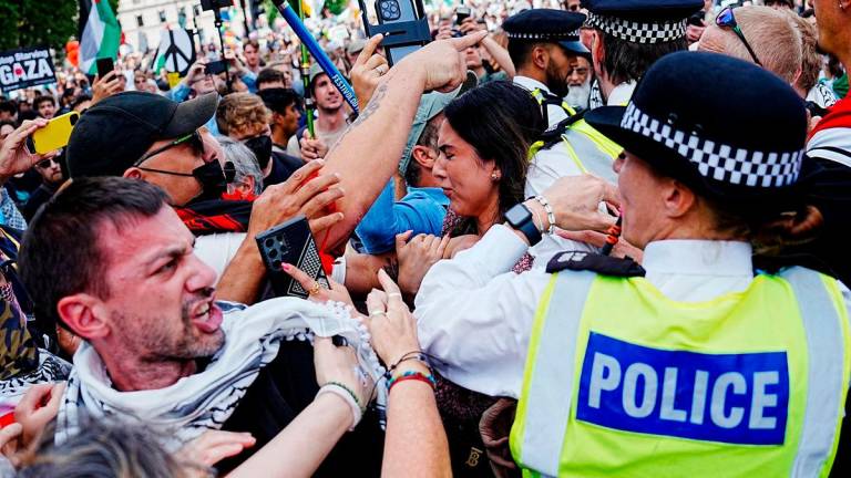 Police officers stand guard as demonstrators attend the “Lift The Ban” rally organised by Defend Our Juries, challenging the British government’s proscription of “Palestine Action” under anti-terrorism laws, in Parliament Square, in London, Britain, September 6, 2025. REUTERS/Carlos Jasso
