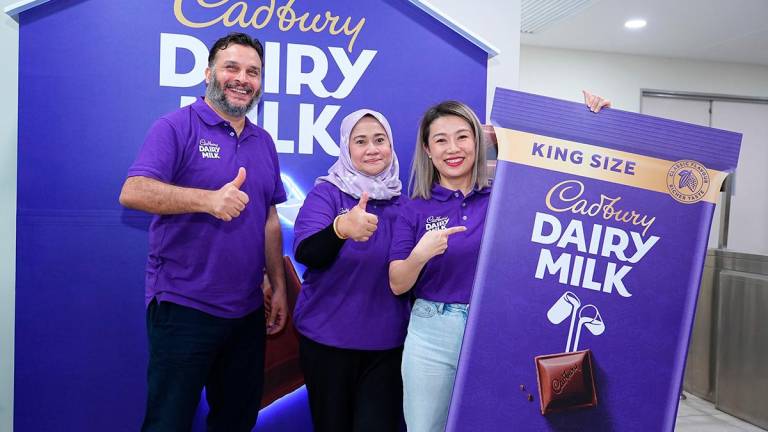 From left: Mondelez International (Malaysia) manufacturing director Abdallah Habib, Mondelez International (Malaysia &amp; Singapore) corporate and government affairs head Raja Zalina Raja Safran and See unveiling the Cadbury King Size 200gm bar in Shah Alam today.